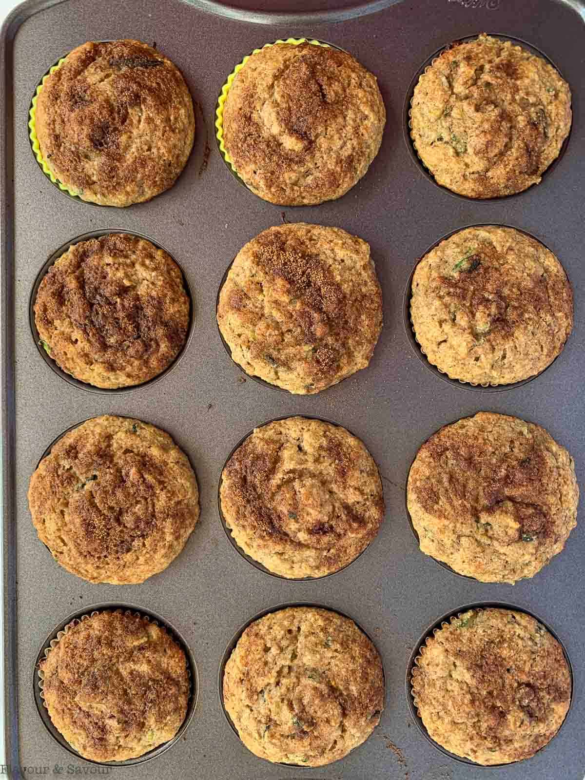 Baked zucchini banana muffins in a muffin pan.