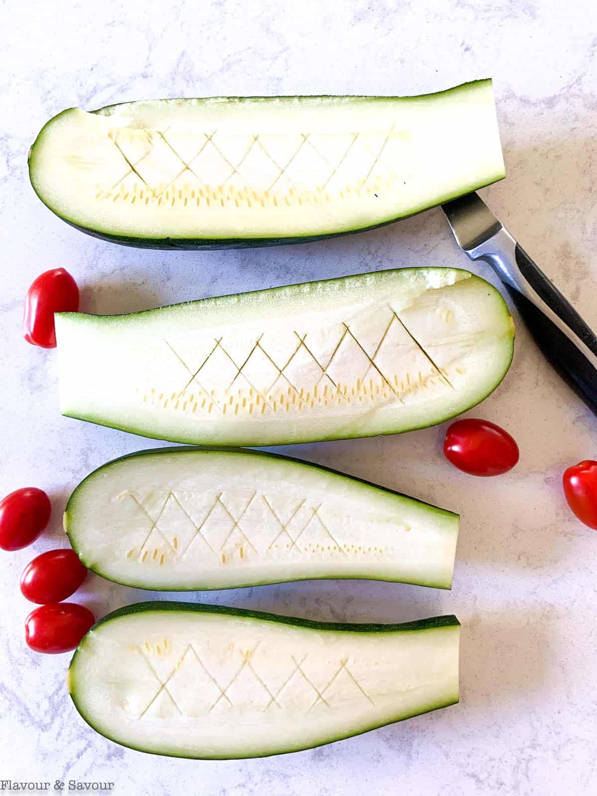 Zucchini halves scored with a sharp knife