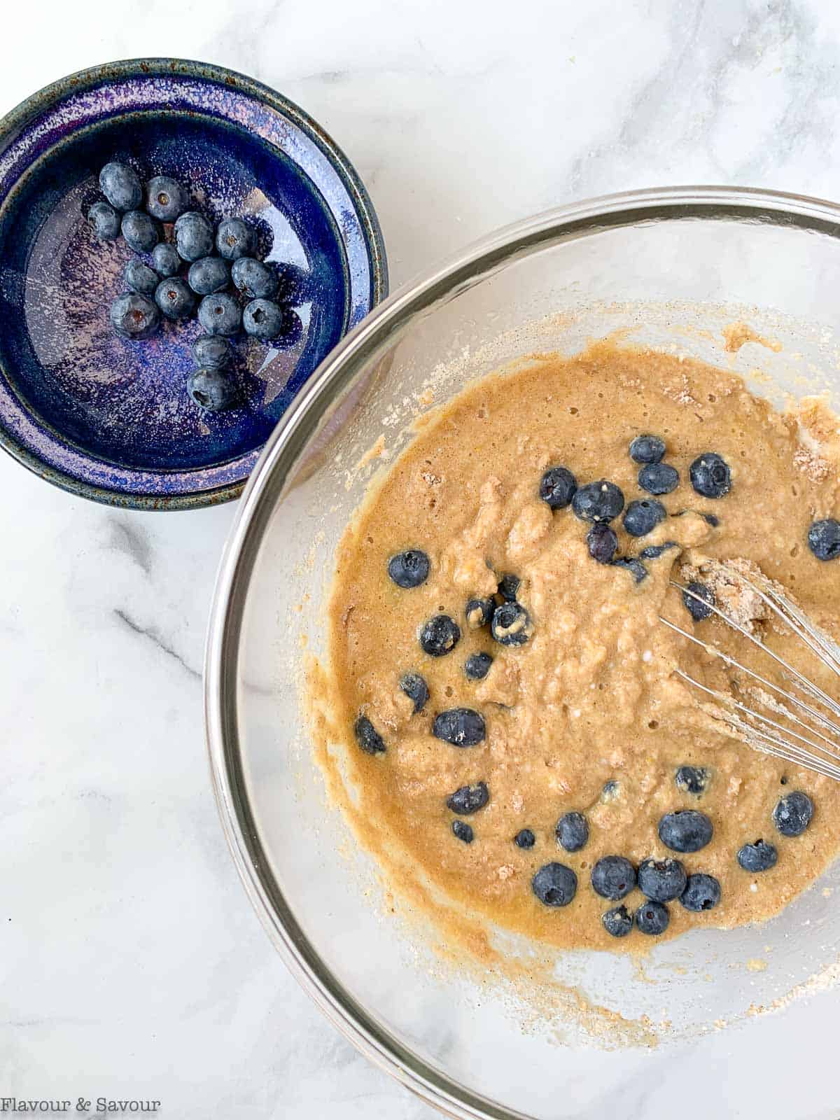 adding blueberries to batter for blueberry banana bread