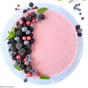 Blackberry Cheesecake Ice Cream Cake decorated with blackberries and blueberries