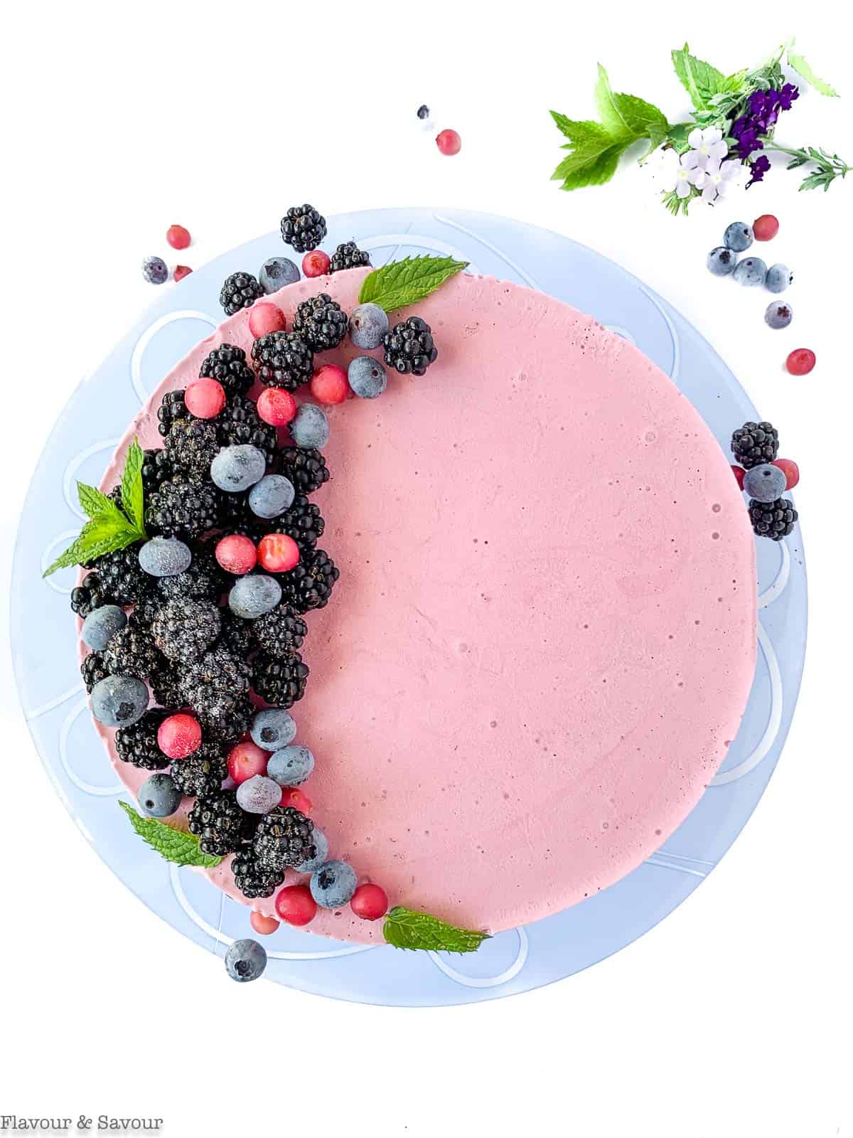 Overhead view of Blackberry Ice Cream Cheesecake decorated with blackberries and blueberries