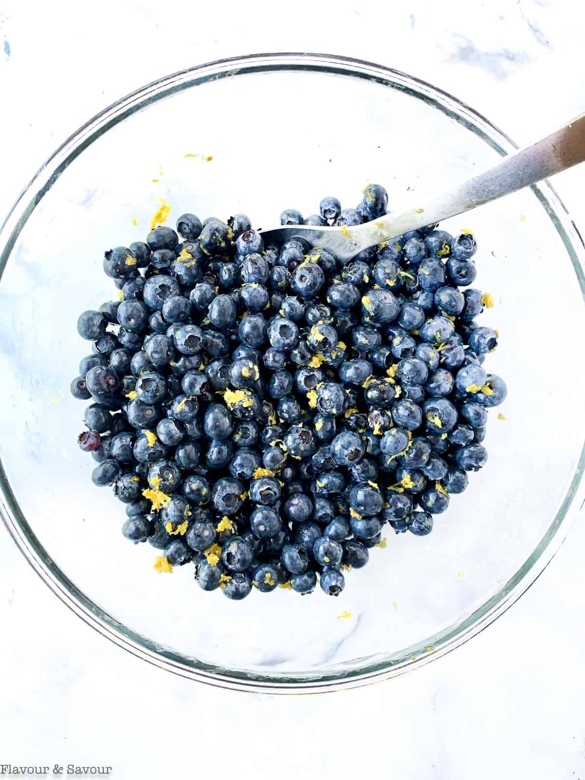 Blueberries in a bowl withe honey, Limoncello and lemon zest.