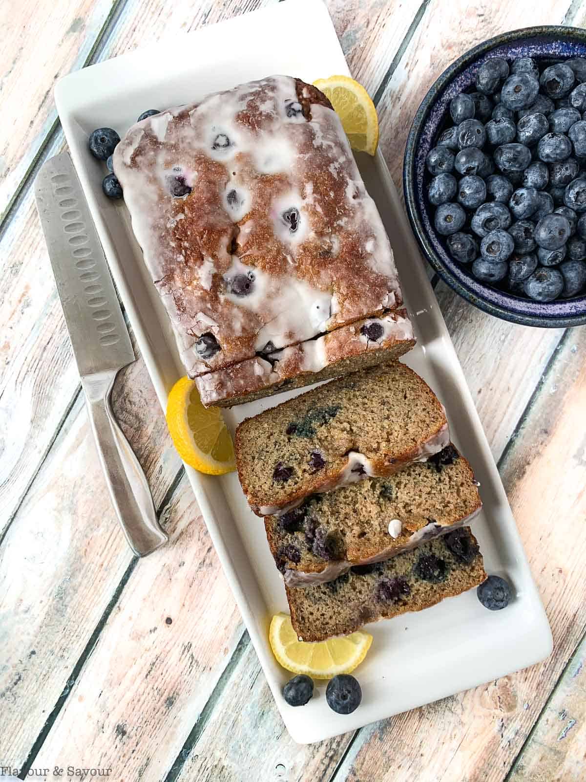 Grain Free Blueberry Banana Bread with a bowl of blueberries