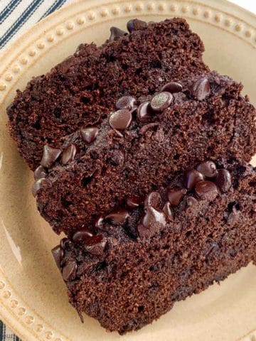 Three slices of double chocolate zucchini bread with chocolate chip topping