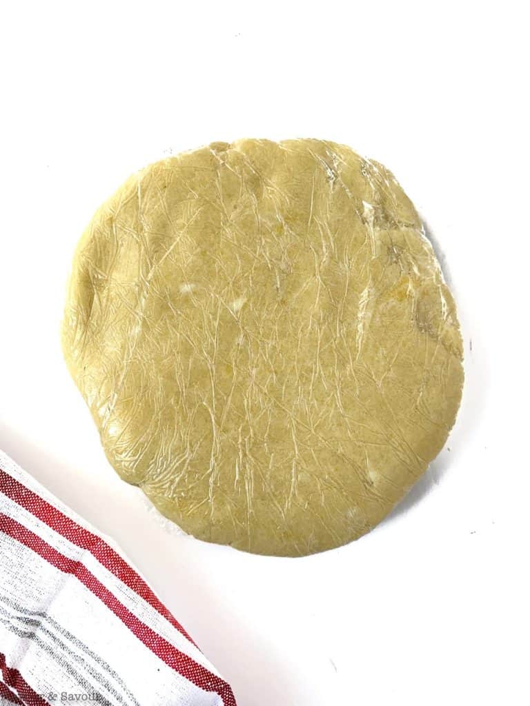 Gluten-free pastry disc wrapped in plastic wrap