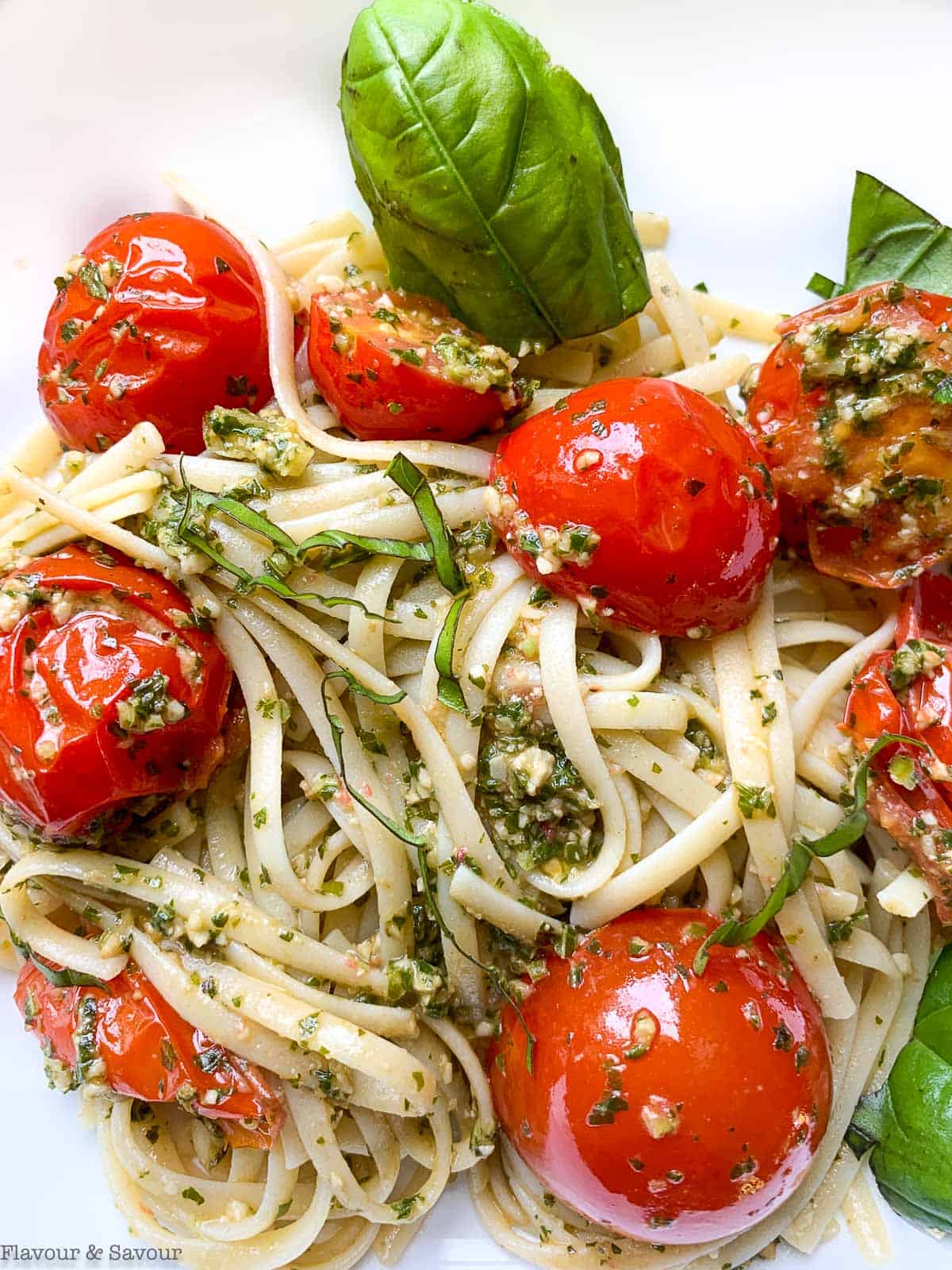 Linguini with pesto and tomatoes.