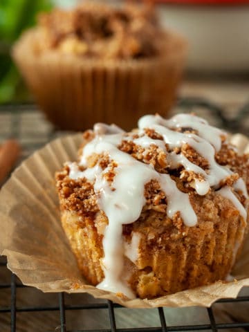 Close up view of a Vanilla Glazed Apple Muffin with Maple Cinnamon Streusel