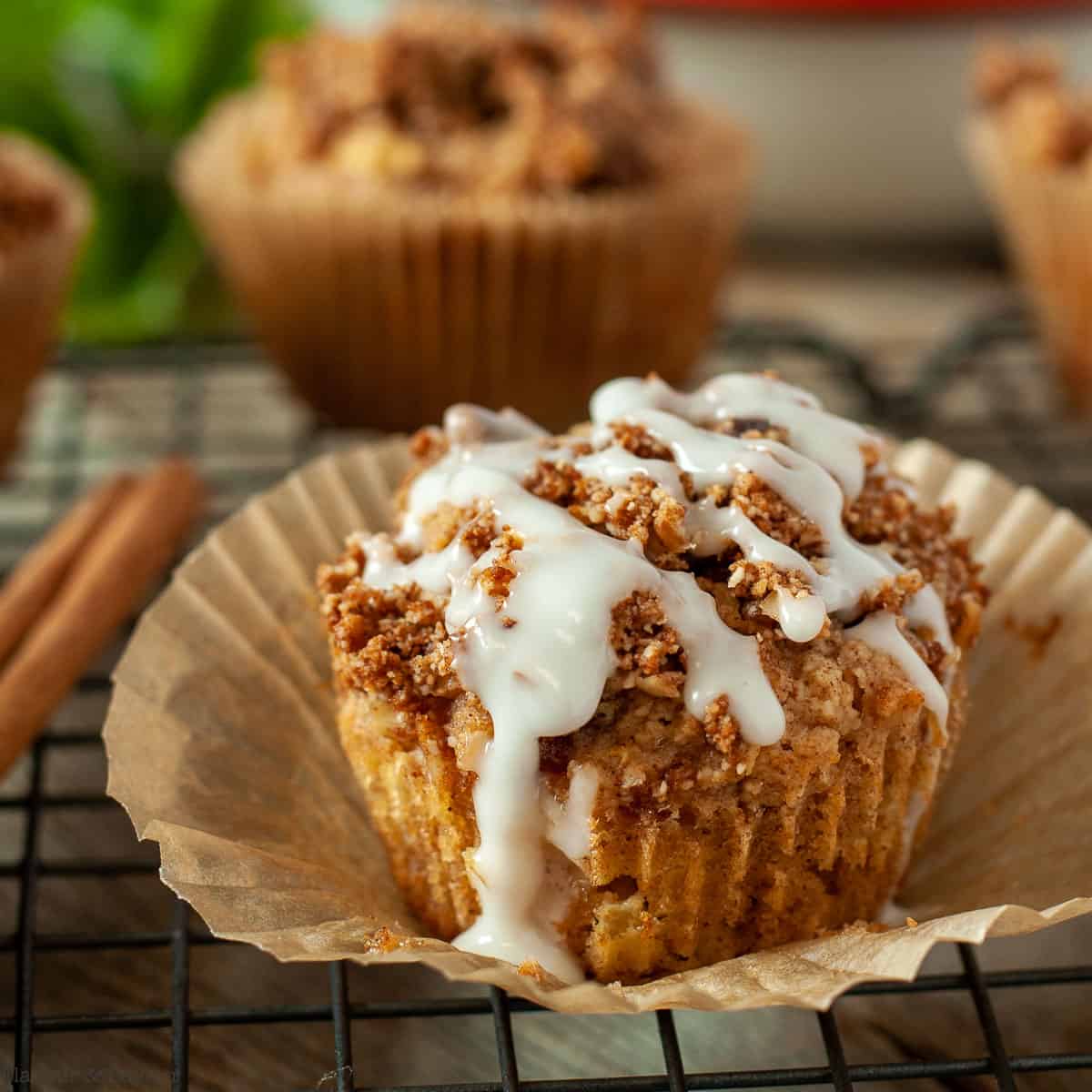 Close up view of a Vanilla Glazed Apple Muffin with Maple Cinnamon Streusel