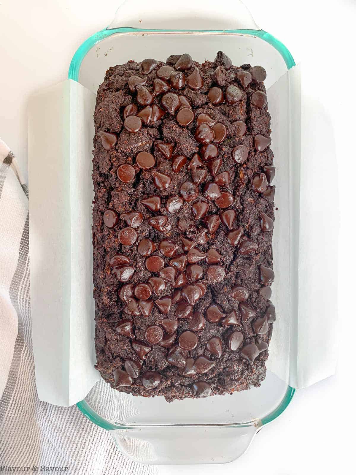Double chocolate zucchini bread in a lined loaf pan.