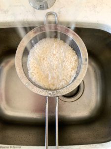 Rinsing rice through a sieve