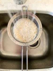 Rinsing rice through a sieve