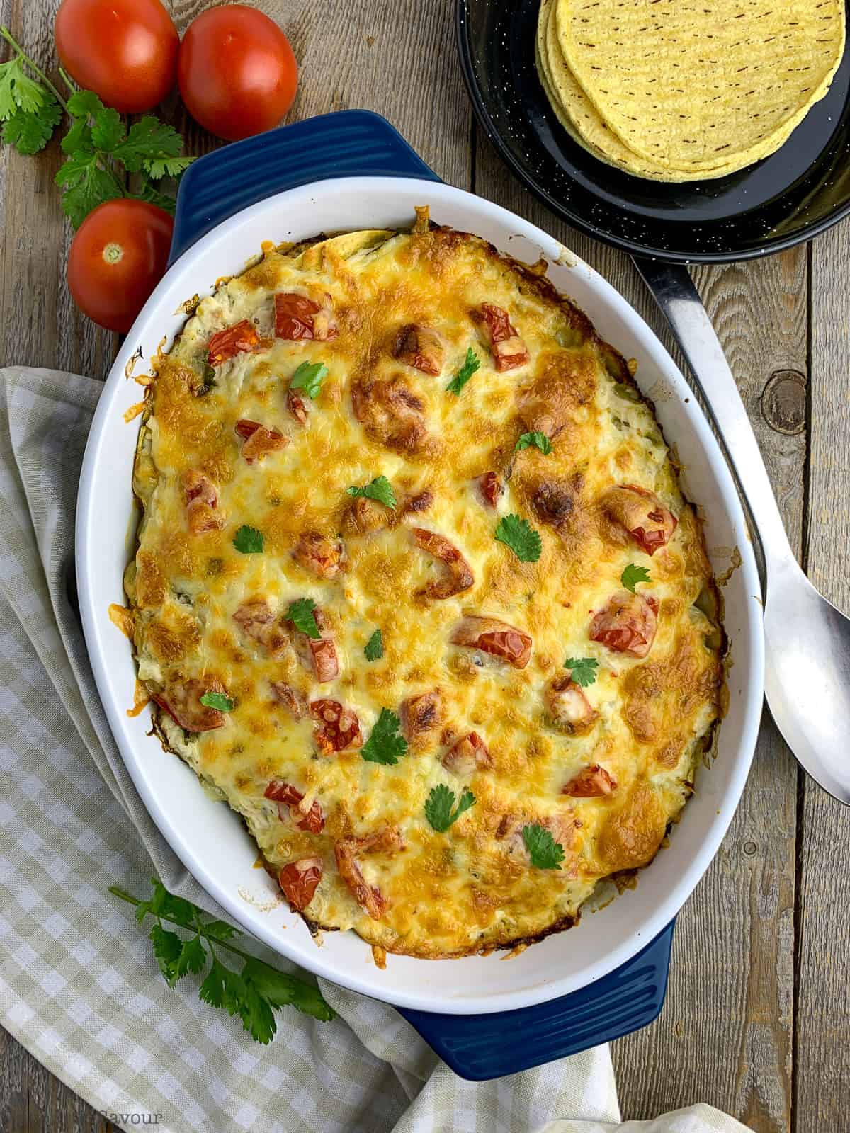 Salsa Verde Chicken Tortilla Bake in a blue casserole dish.