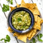 Tomatillo Salsa Verde in a blue bowl with tortilla chips