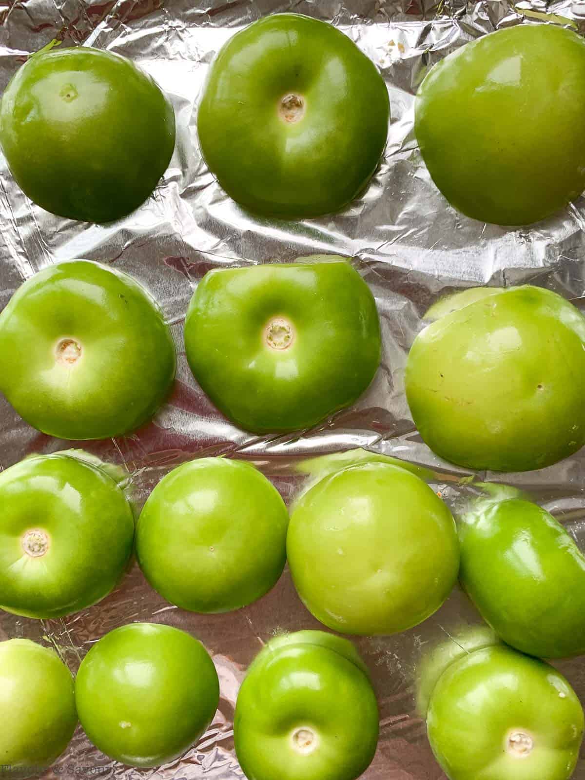 Tomatillos on a foil-lined baking sheet