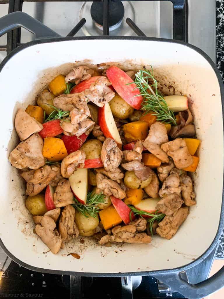 adding the browned chicken pieces back to the pot