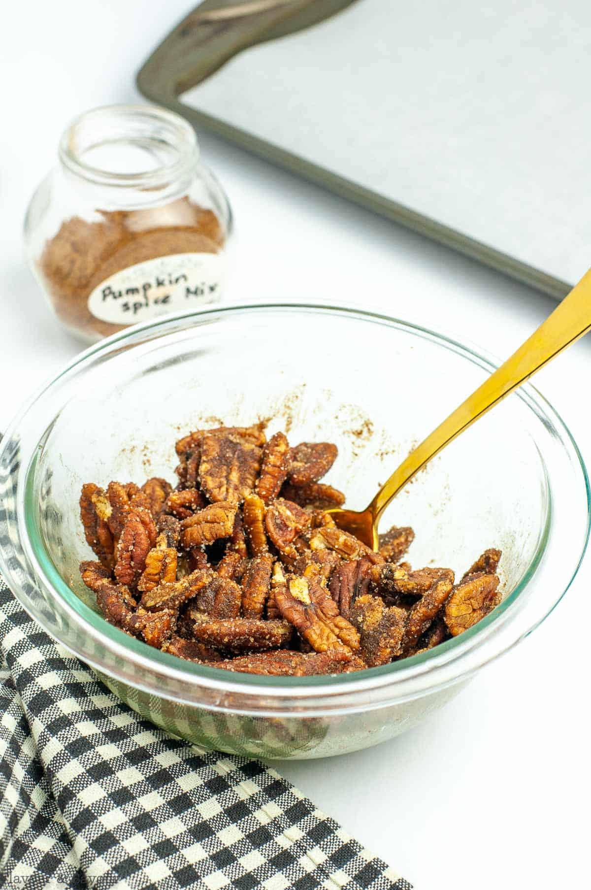 Pumpkin Spice Pecans in a bowl with a spoon