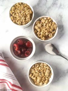 Four ramekins with cherry crisp, one without topping