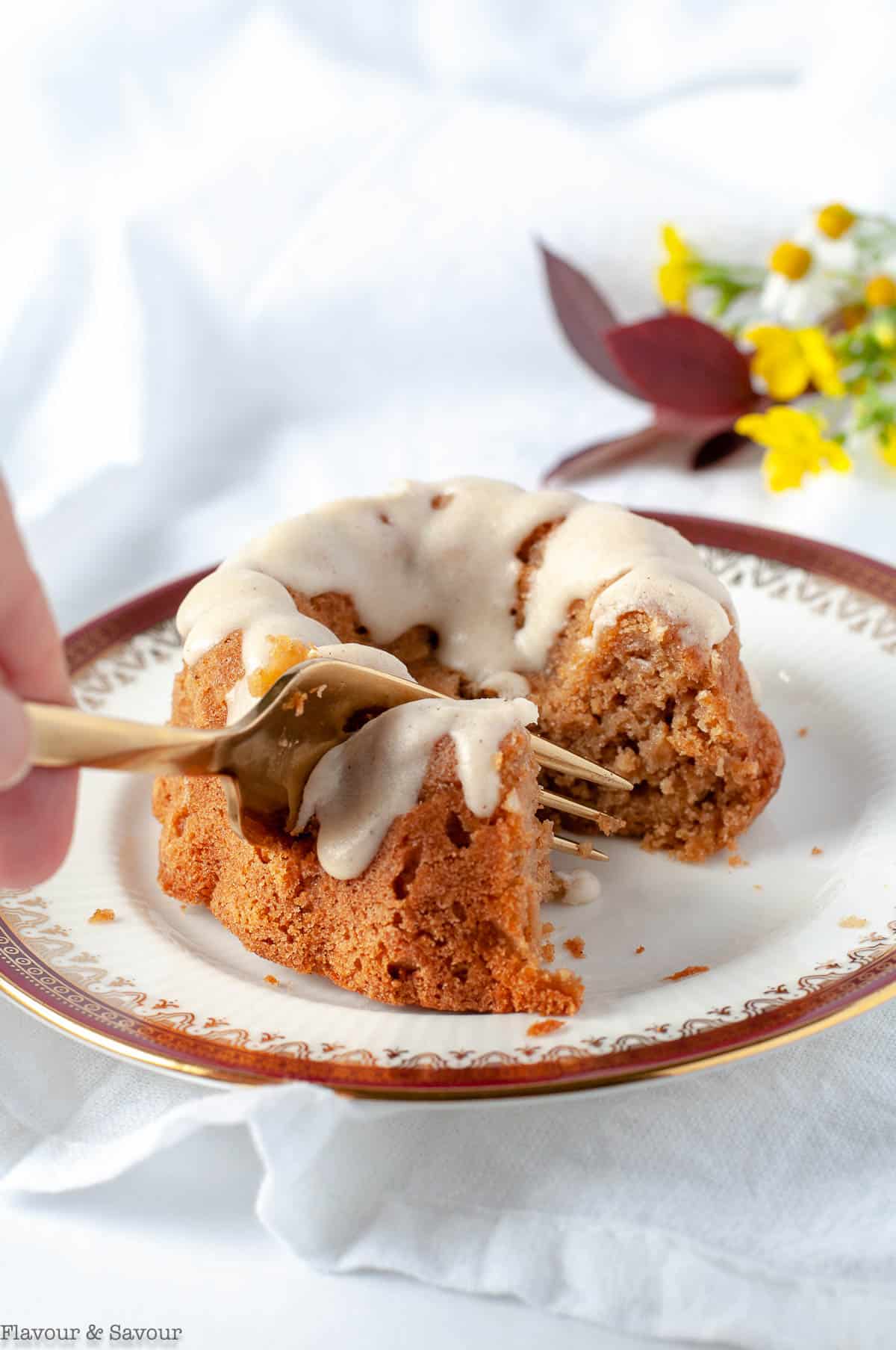 Cutting into a Mni Apple Bundt Cake with a fork
