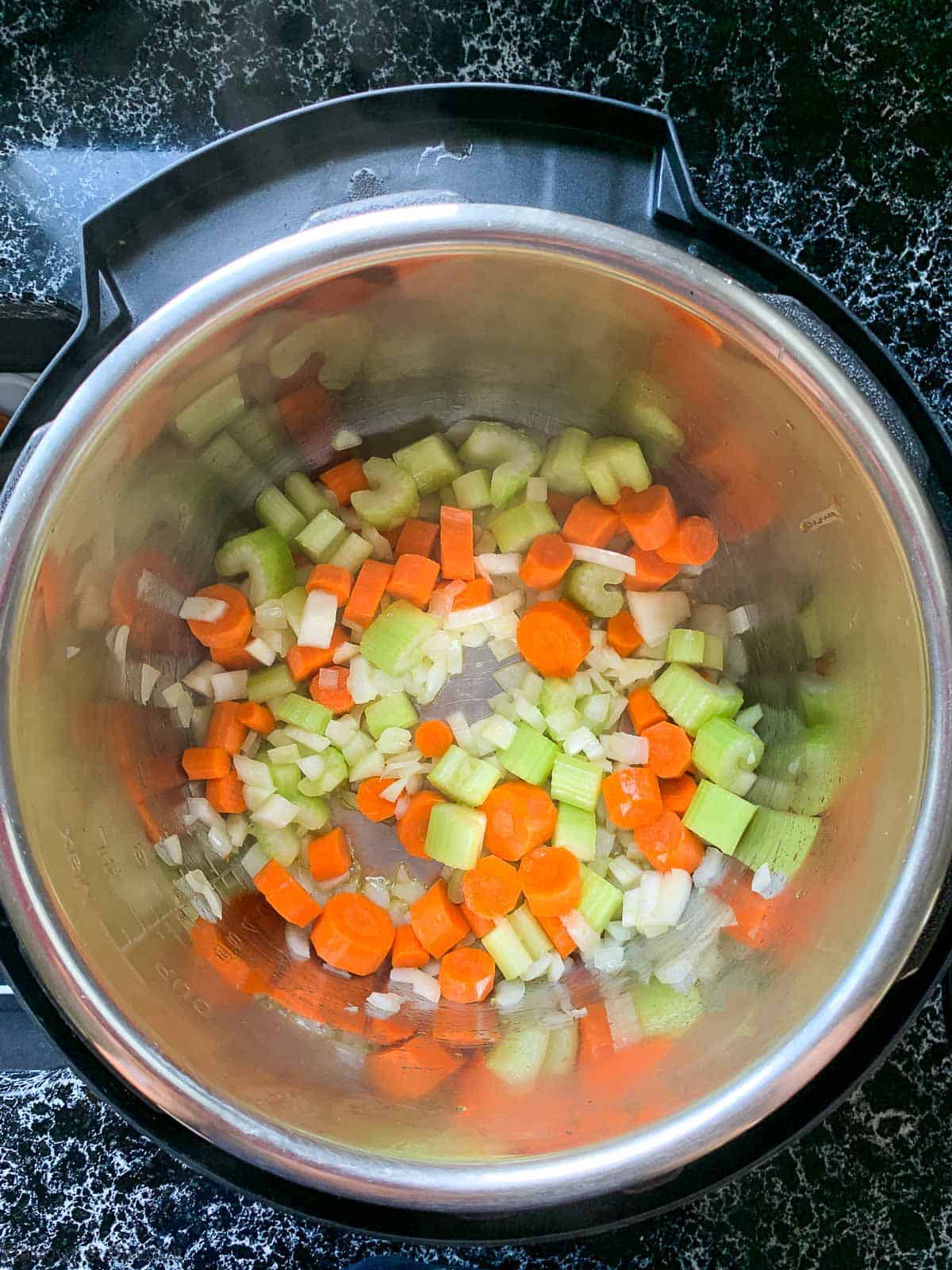 Preparing Minestrone Soup step 1, sautéed vegetables in an Instant pot.