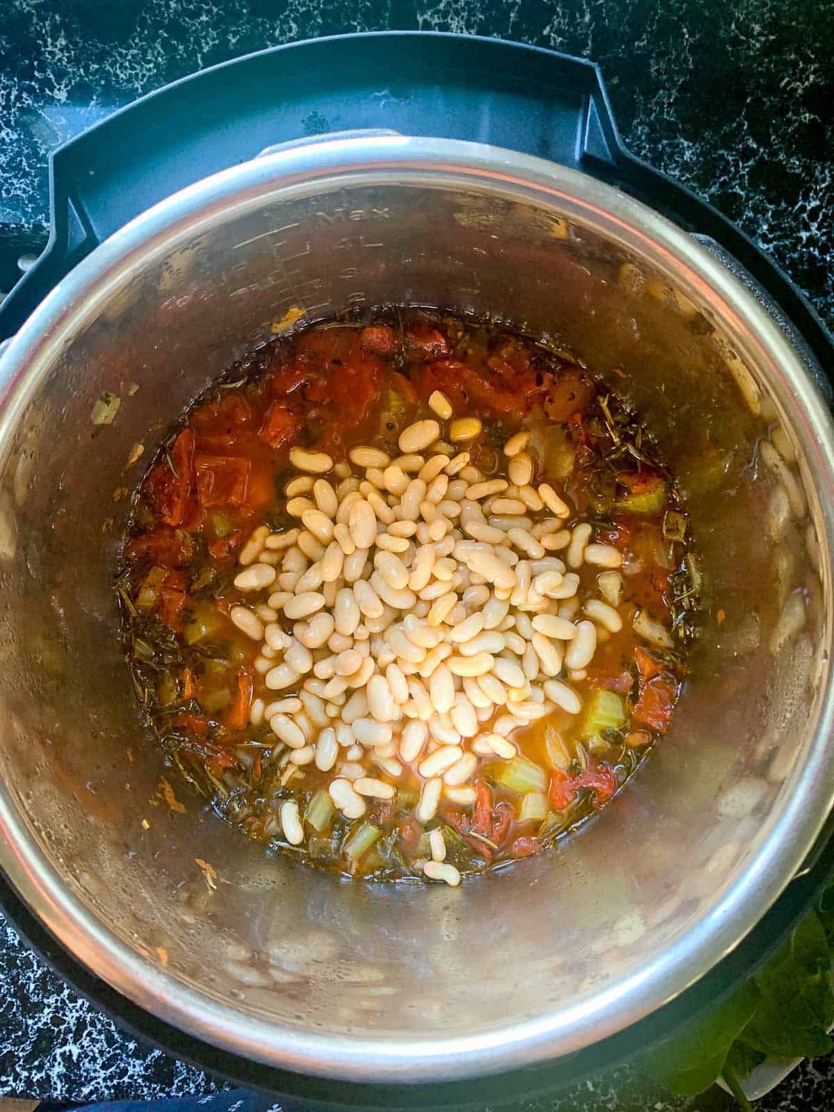 Preparing Minestrone Soup step 3, adding beans.