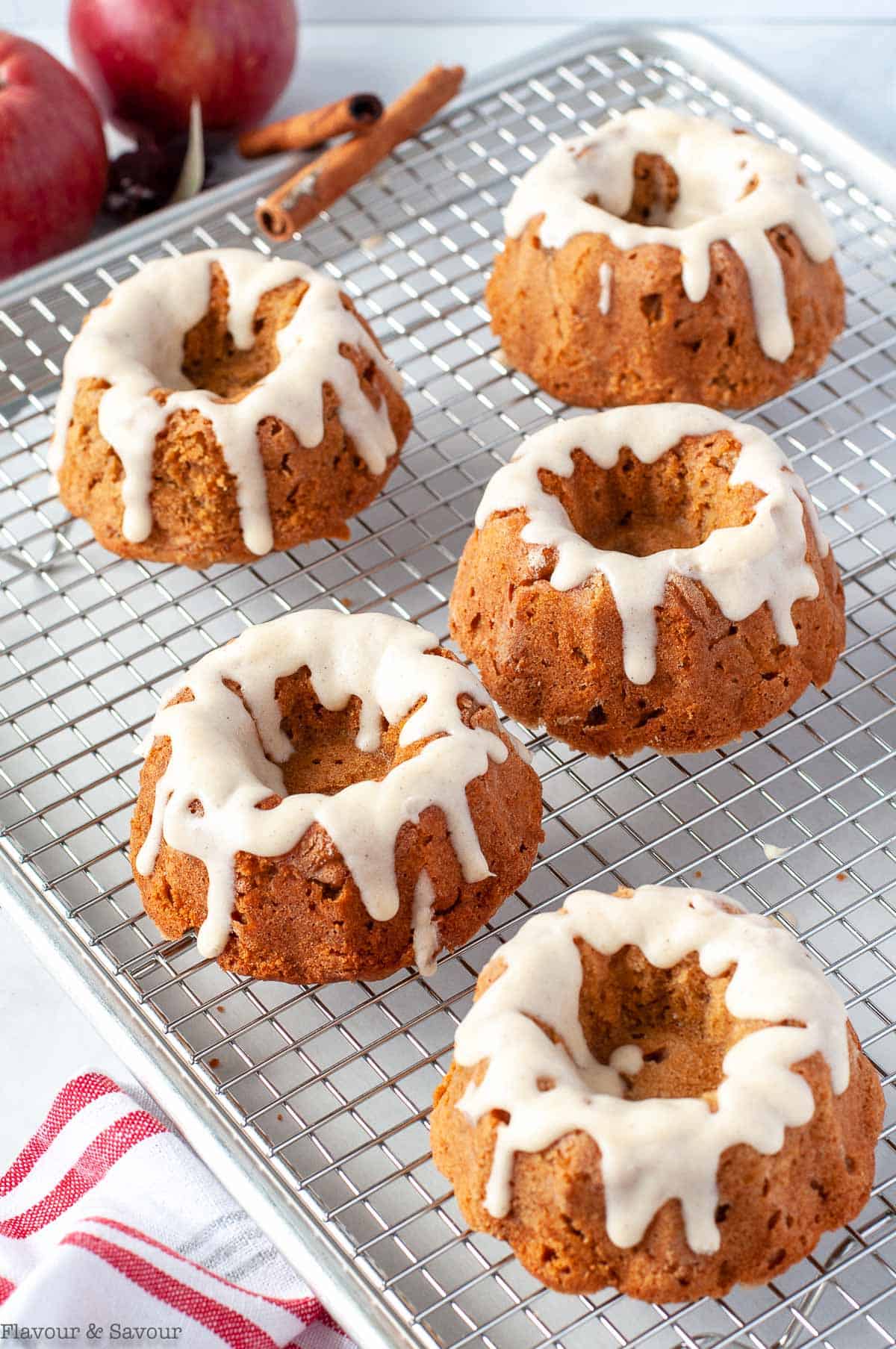 Glazed Mini Apple Bundt cakes on a cooling rack