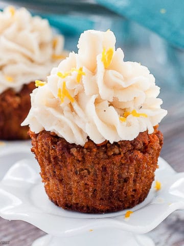 a Paleo Carrot Cake Cupcake on a pedestal stand