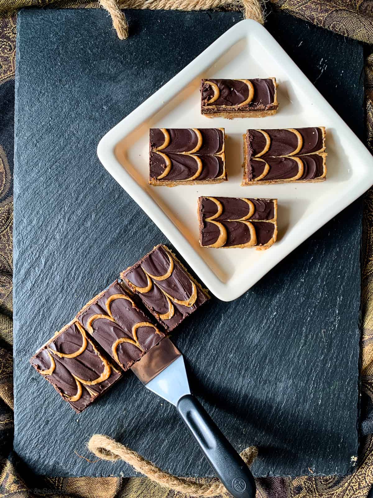 Peanut Butter Swirl Chocolate Bars on a black slate serving board