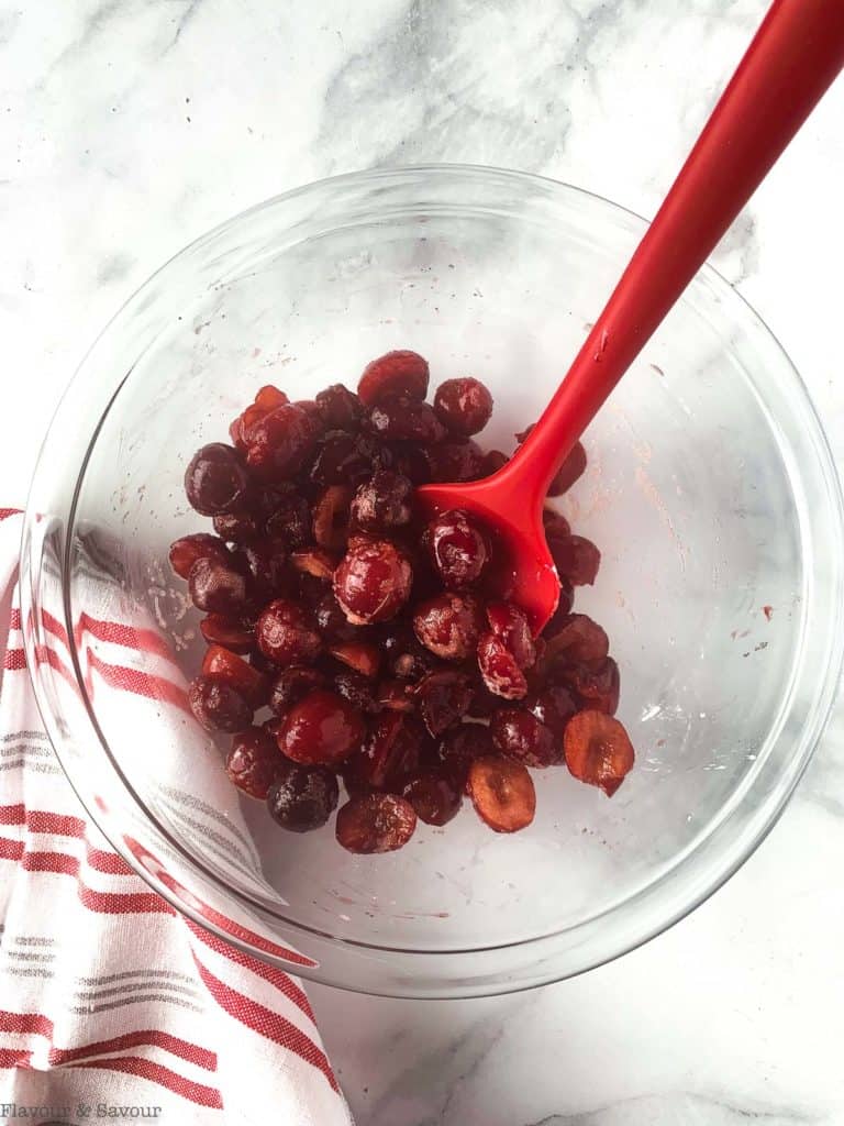 Cherries in a bowl with a spoon