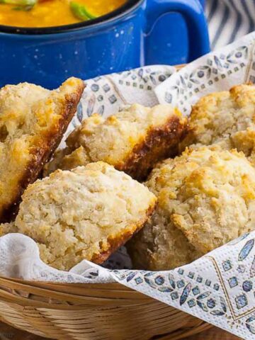 Herbed gluten free baking powder biscuits in a basket.