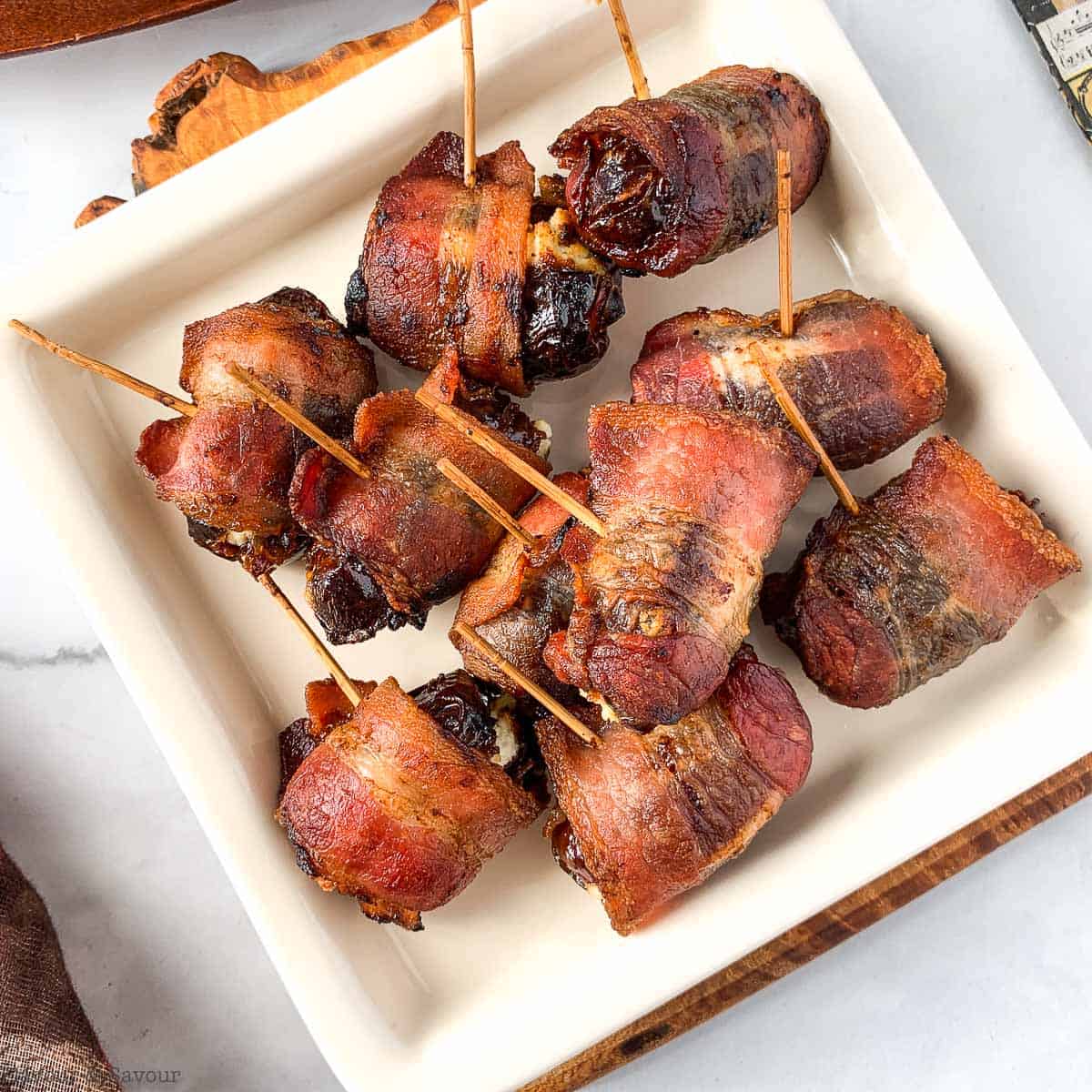 Close up view of stuffed dates wrapped in bacon