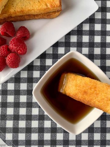 Dipping French Toast Stick in maple syrup