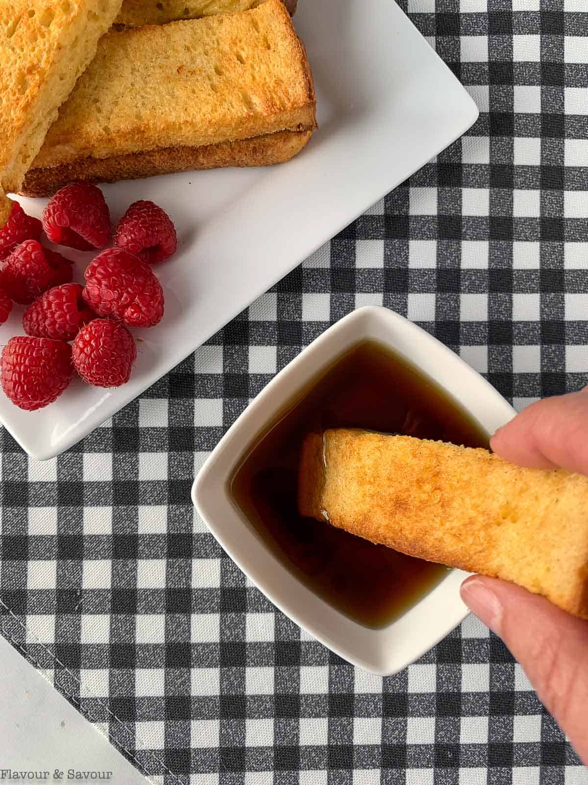 Dunking a French Toast stick in maple syrup