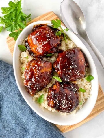 Overhead image of Instant Pot Sticky Chicken Thighs in a bowl with a serving spoon