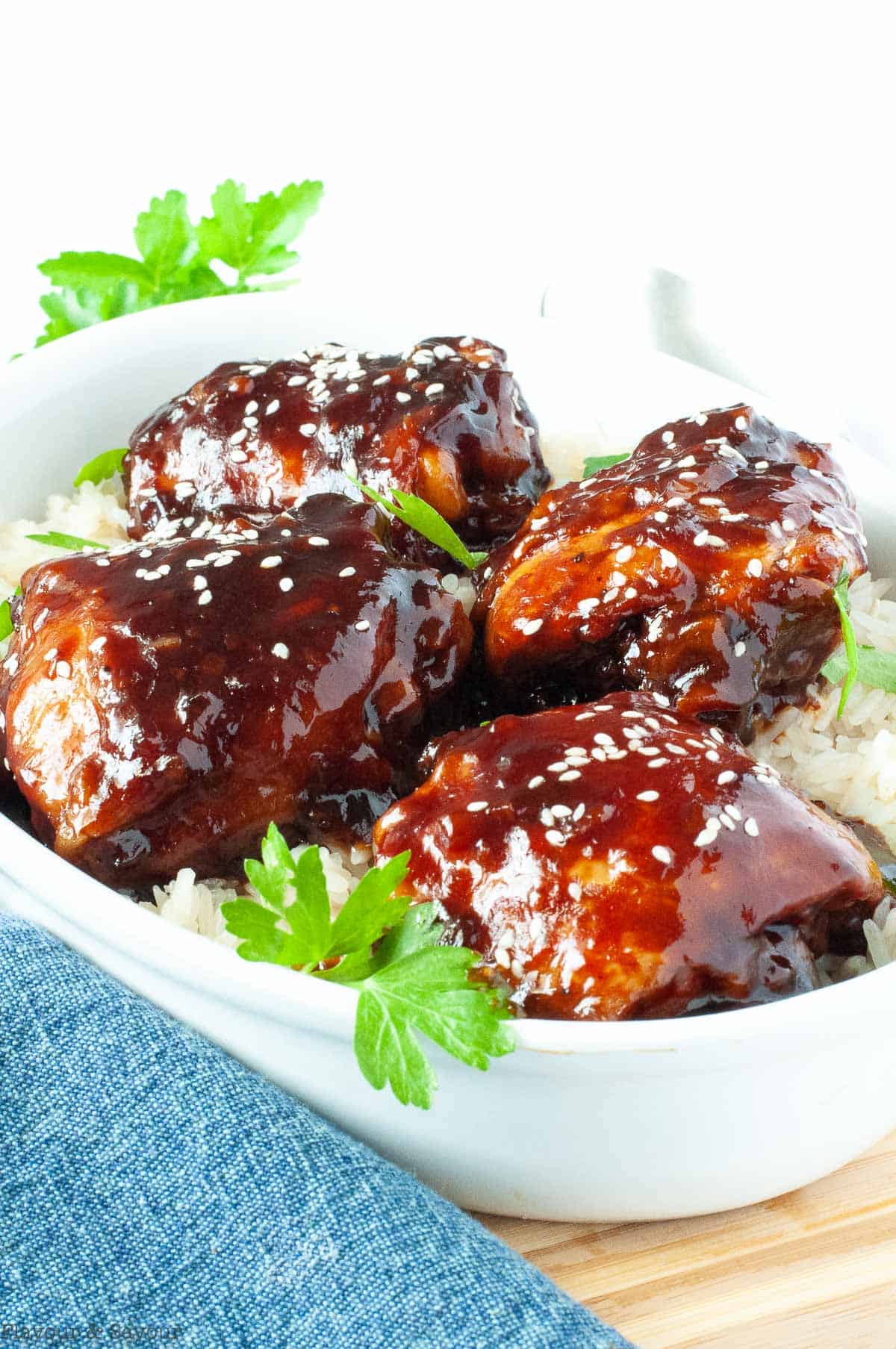 Four Sticky Chicken Thighs on a bed of rice.