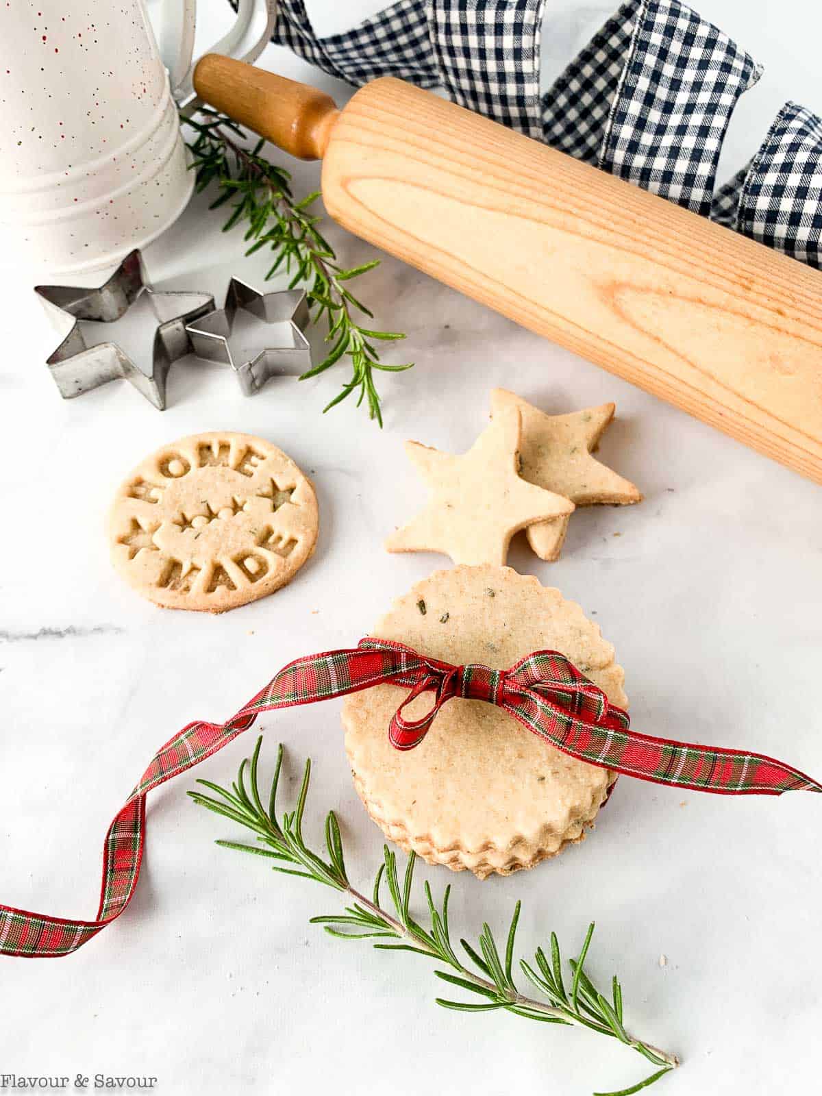 Cookies tied with ribbon with a rolling pin and cookie cutters