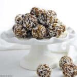 No bake chocolate almond snowballs on a pedestal cake plate.