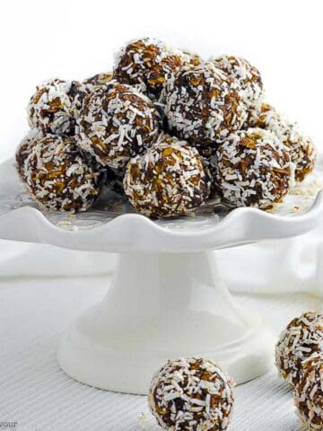 No bake chocolate almond snowballs on a pedestal cake plate.