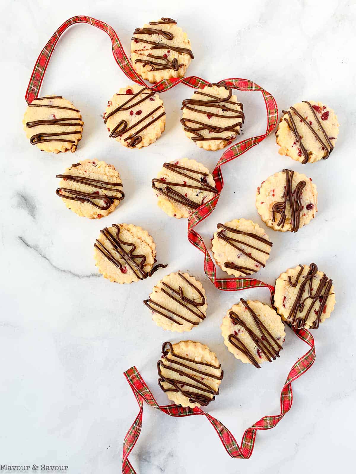 Overhead view of shortbread cookies with plaid ribbon.