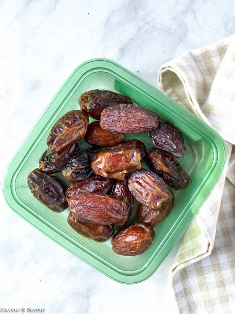 raw Medjool dates in a plastic container