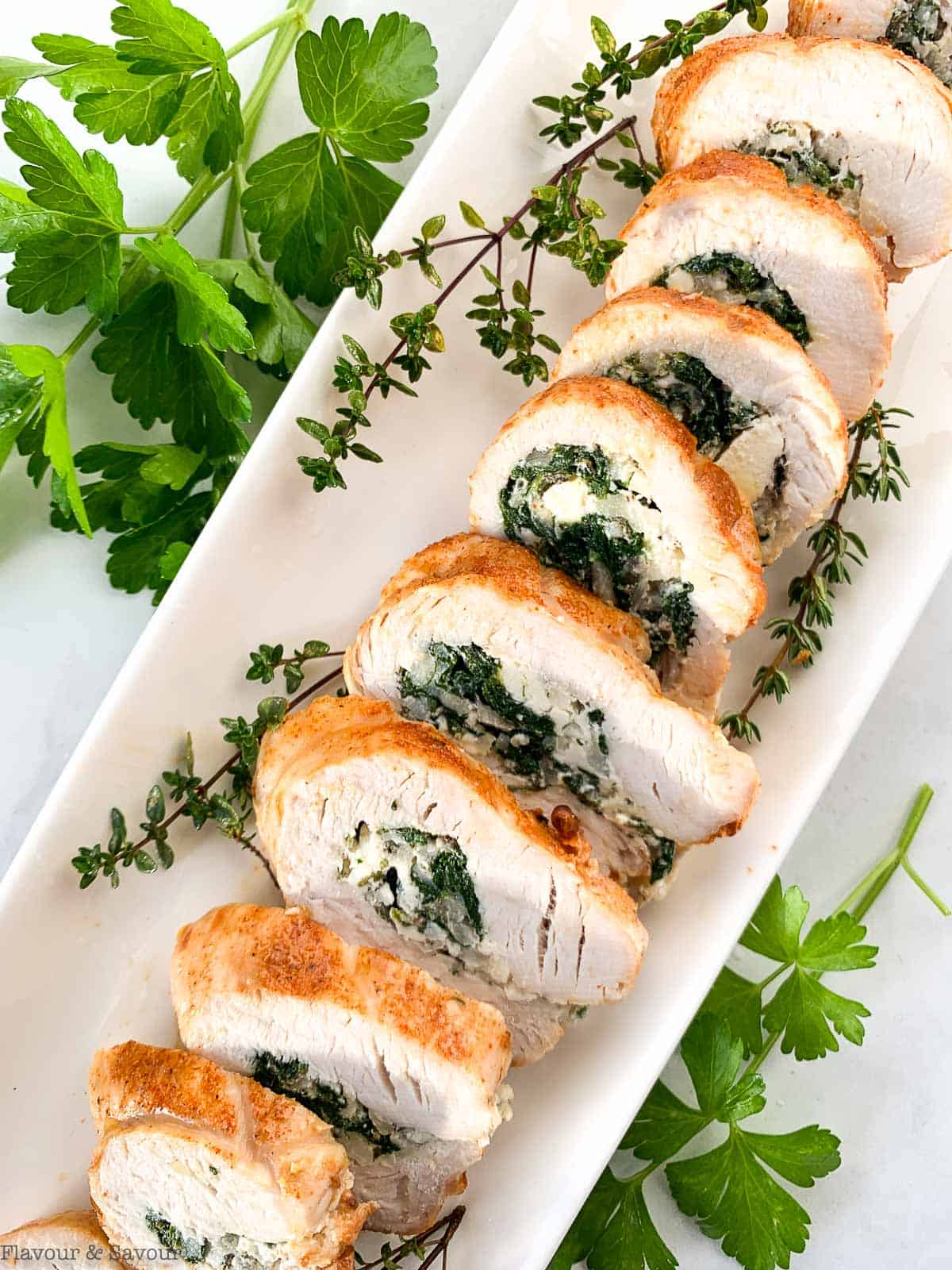 Sliced Air Fryer Stuffed Turkey Roll on a serving platter