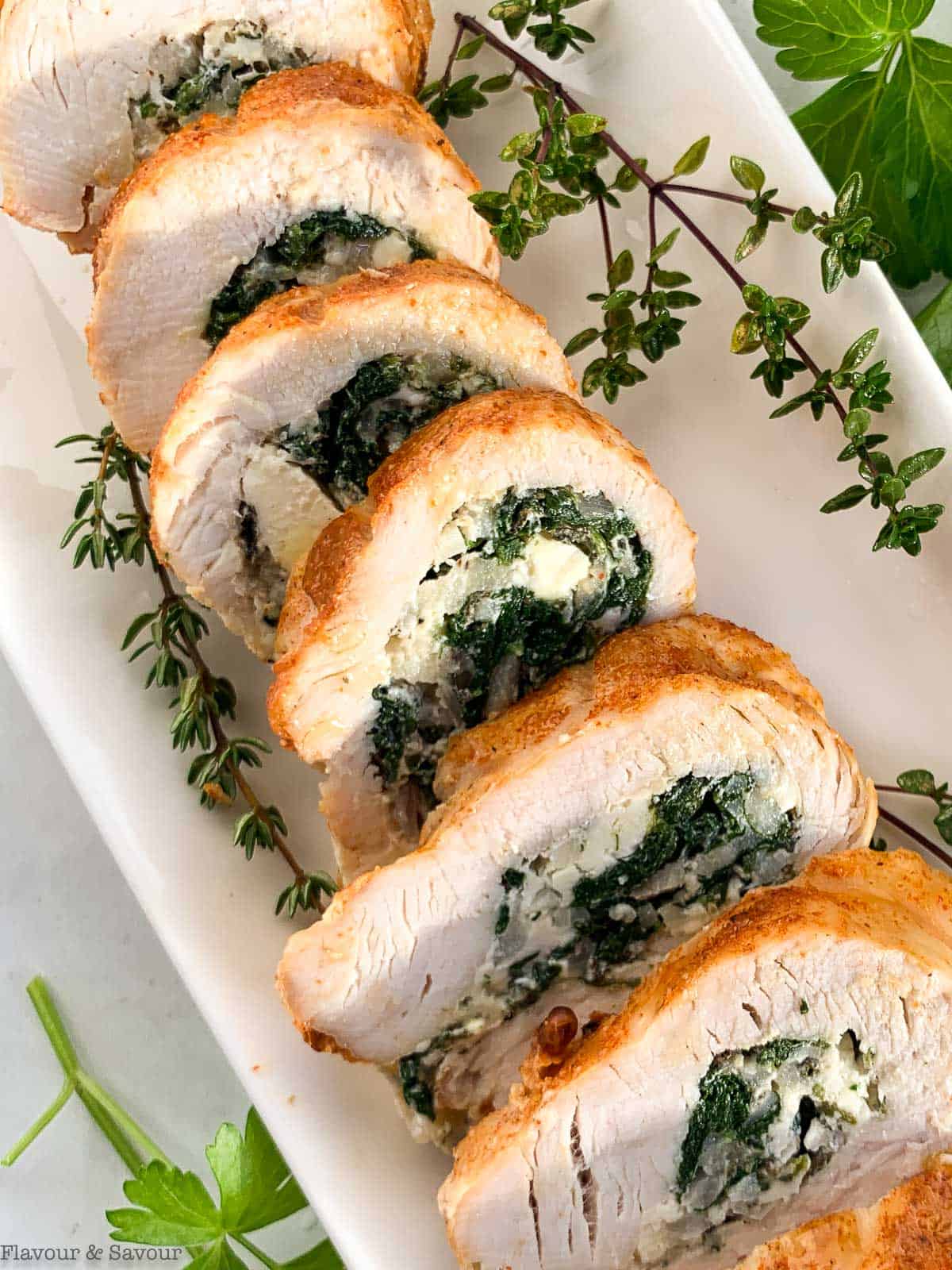 Close up view of slices of stuffed rolled turkey breast