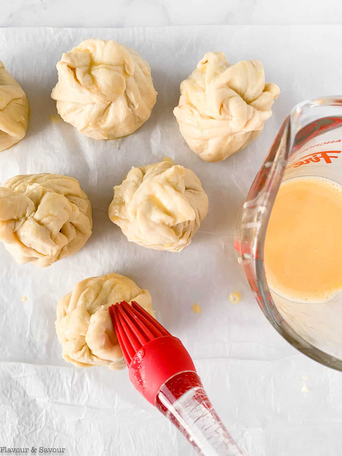 Brushing egg wash on puff pastry