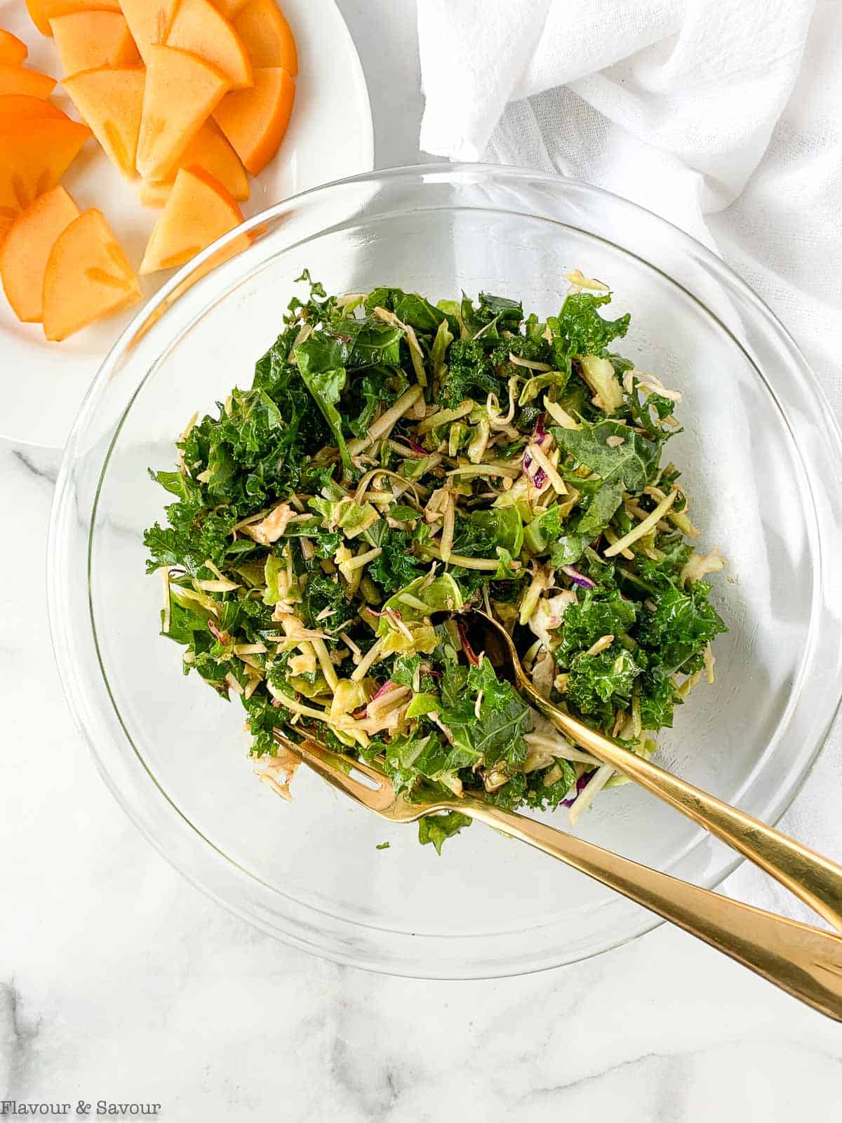 Tossing Kale Slaw with Maple Balsamic Dressing.