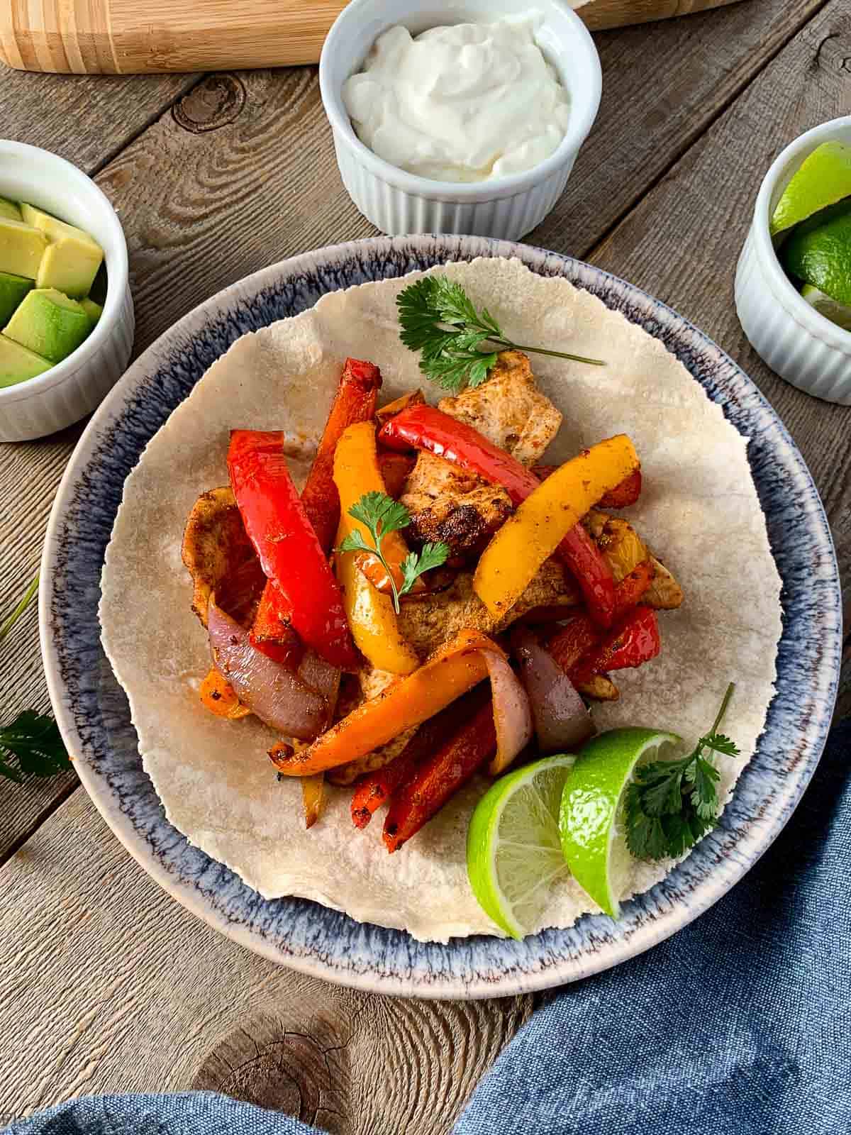 Overhead view of air fryer chicken fajitas ready to eat.