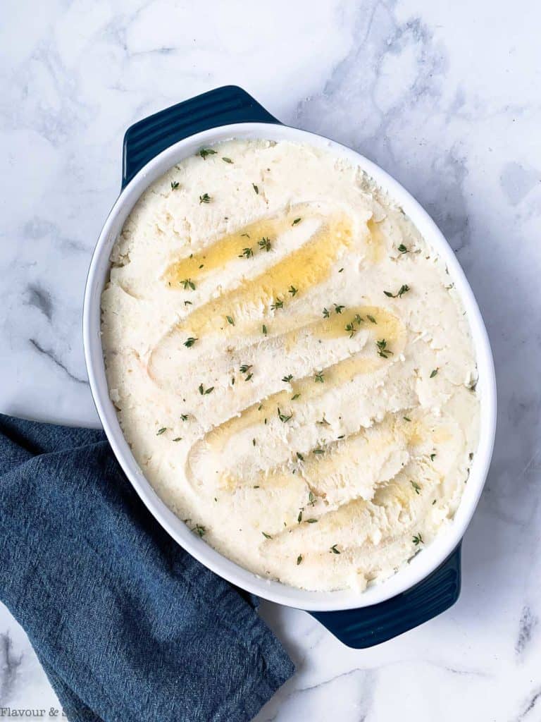 Drizzle mashed potatoes with butter and thyme.