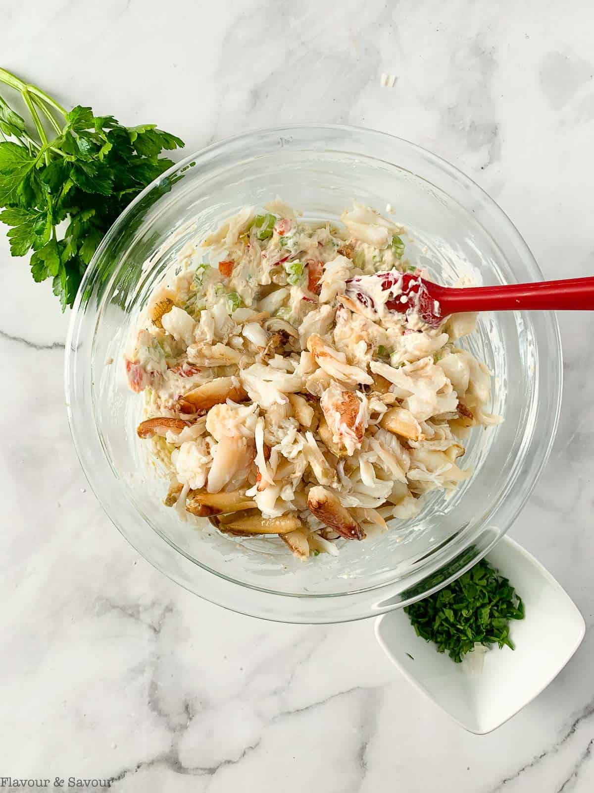 Folding crab meat into dip ingredients.