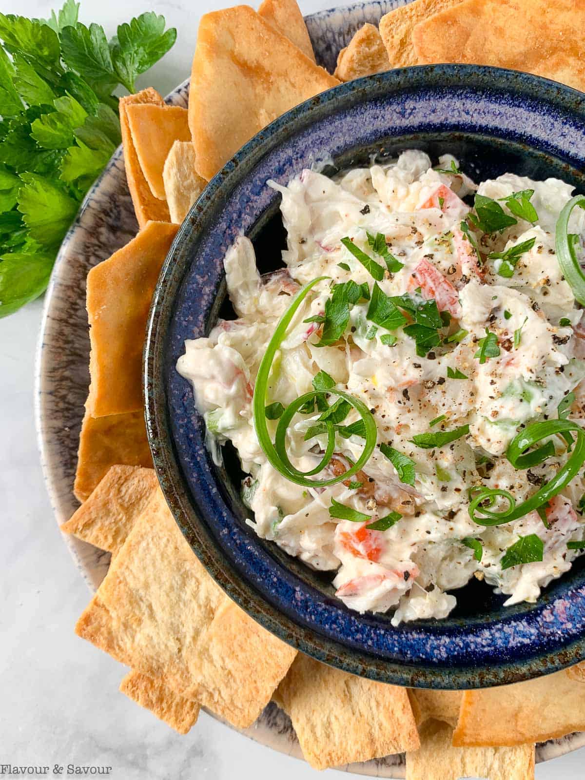 Close up overhead view of cold crab dip surrounded by crackers