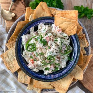 Overhead view of a bowl of crab dip with crackers