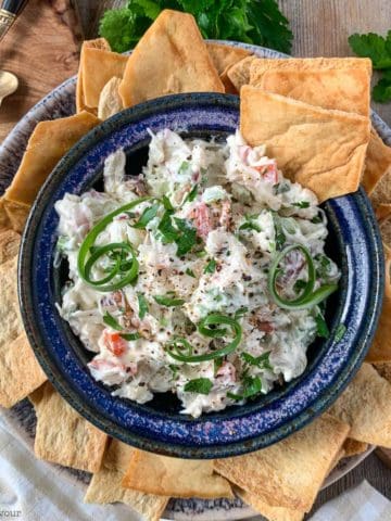 Overhead view of a bowl of crab dip with crackers