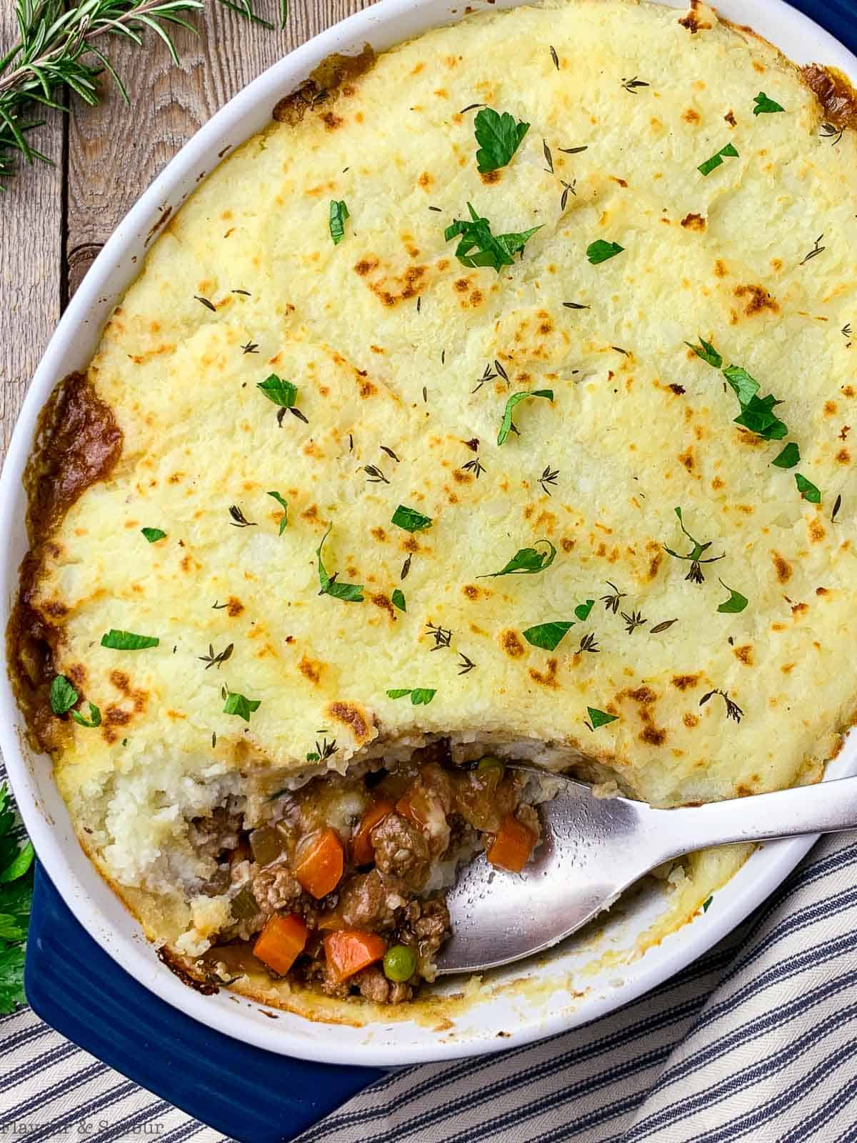 Serving traditional Irish Shepherd's pie with a large spoon